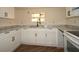 The kitchen features modern white cabinets and a sleek black faucet at 37045 North Ave, Dade City, FL 33523