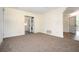 Neutral living room featuring carpeting and an adjacent laundry with a washer and dryer at 37045 North Ave, Dade City, FL 33523