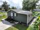 View of home featuring neutral siding, new roof, and meticulously manicured landscaping at 37045 North Ave, Dade City, FL 33523
