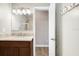 Bathroom features a stone countertop, modern vanity lights, and shower at 3917 Casaba Loop, Valrico, FL 33596