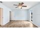 Bedroom with light blue walls, wood floors, a window and a ceiling fan at 3917 Casaba Loop, Valrico, FL 33596
