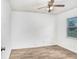 Bedroom features a ceiling fan, wood floors, a window letting in natural light at 3917 Casaba Loop, Valrico, FL 33596