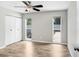Bedroom with wood floors, two windows, double closet and light gray walls at 3917 Casaba Loop, Valrico, FL 33596