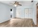 Bedroom with ample closet space, light blue walls, wood floors and a window at 3917 Casaba Loop, Valrico, FL 33596