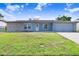 Charming single-story home featuring a stone accent wall and a well-manicured lawn in a residential neighborhood at 3917 Casaba Loop, Valrico, FL 33596