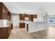 Modern kitchen featuring granite countertops, wooden cabinets, stainless steel appliances, and tiled backsplash at 3917 Casaba Loop, Valrico, FL 33596