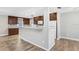 Modern kitchen with granite countertops and wood-look flooring, creating an inviting space for cooking and entertaining at 3917 Casaba Loop, Valrico, FL 33596