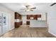 Open kitchen area with wood-look flooring and a view into the living area, creating a warm and inviting space at 3917 Casaba Loop, Valrico, FL 33596