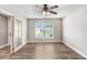 Bright living room features stylish wood floors, ceiling fan, and a window letting in natural light at 3917 Casaba Loop, Valrico, FL 33596