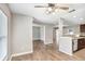 Open concept living space featuring wood-look flooring and a view into the dining and kitchen area, ideal for entertaining at 3917 Casaba Loop, Valrico, FL 33596