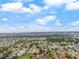 Expansive aerial view showcasing the lush community, surrounding neighborhood, and distant water views at 4036 Davit Dr, New Port Richey, FL 34652