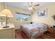 Sunlit bedroom with a comfortable bed, dresser, and large window offering a cozy and bright living space at 4036 Davit Dr, New Port Richey, FL 34652