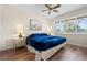 Cozy bedroom featuring a comfortable bed, ceiling fan, and a large window providing ample natural light at 4036 Davit Dr, New Port Richey, FL 34652