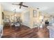 Well-lit dining area with wood floors, a decorative ceiling fan, and adjacent living space at 4036 Davit Dr, New Port Richey, FL 34652