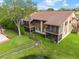 Back aerial view of condo featuring screened in patios and landscaping at 4036 Davit Dr, New Port Richey, FL 34652
