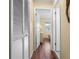 Hallway with wood floors leading to a bright bedroom, showcasing closet space and natural light at 4036 Davit Dr, New Port Richey, FL 34652