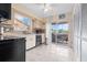 Efficient kitchen featuring stainless sink and black appliances, with outdoor access at 4036 Davit Dr, New Port Richey, FL 34652
