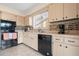 Efficient kitchen featuring tile backsplash, black appliances, and tile floors at 4036 Davit Dr, New Port Richey, FL 34652