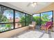 Enclosed lanai with view of backyard pool and comfortable seating at 4036 Davit Dr, New Port Richey, FL 34652