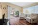 Cozy living room with wood floors, and view of the enclosed lanai at 4036 Davit Dr, New Port Richey, FL 34652