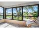 Enclosed patio showing water view with seating, and stone tiled floor at 4036 Davit Dr, New Port Richey, FL 34652
