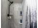 Stylish shower with gray tile, recessed shelves, and rainfall shower head fixture at 4036 Davit Dr, New Port Richey, FL 34652