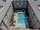 Aerial view of a complex showcasing the central pool area with lounge seating at 4221 W Spruce St # 2302, Tampa, FL 33607