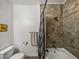 Bathroom featuring a bathtub with tiled walls and wood-look floors at 4221 W Spruce St # 2302, Tampa, FL 33607