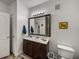 Bathroom showing a vanity with a dark wood cabinet, framed mirror, and wood-look flooring at 4221 W Spruce St # 2302, Tampa, FL 33607
