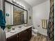Bathroom featuring a vanity with a dark wood cabinet, framed mirror, and wood-look flooring at 4221 W Spruce St # 2302, Tampa, FL 33607