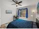 Bright bedroom with a window, ceiling fan, and a workspace is perfect for relaxation and productivity at 4221 W Spruce St # 2302, Tampa, FL 33607