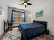 Cozy bedroom with blue accents, a ceiling fan, and a functional workspace by the window at 4221 W Spruce St # 2302, Tampa, FL 33607