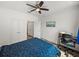 Well-lit bedroom with a desk, multiple closets, and a ceiling fan offers ample storage and workspace at 4221 W Spruce St # 2302, Tampa, FL 33607