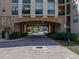 Beautiful condominium entrance featuring a brick archway and covered parking at 4221 W Spruce St # 2302, Tampa, FL 33607