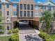 Beautiful condominium exterior featuring brick archway, balconies, and well-maintained landscaping at 4221 W Spruce St # 2302, Tampa, FL 33607