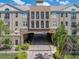 Stunning building exterior featuring stone accents, neutral paint, black metal balconies, and lush landscaping at 4221 W Spruce St # 2302, Tampa, FL 33607