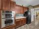 Functional kitchen includes stainless steel oven, dark wood cabinets, and tiled flooring at 4221 W Spruce St # 2302, Tampa, FL 33607