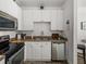 Close-up of kitchen featuring stainless steel appliances and white cabinets at 4221 W Spruce St # 2302, Tampa, FL 33607