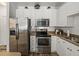 Well-lit kitchen featuring stainless steel appliances, white cabinets, and a modern design at 4221 W Spruce St # 2302, Tampa, FL 33607