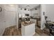 Cozy kitchen with white cabinets, stainless steel appliances, and wood-style flooring at 4221 W Spruce St # 2302, Tampa, FL 33607