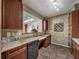 Well-maintained kitchen featuring tiled floors, granite countertops, and modern appliances at 4221 W Spruce St # 2302, Tampa, FL 33607