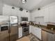 Bright kitchen with white cabinets, stainless steel appliances, and modern countertops at 4221 W Spruce St # 2302, Tampa, FL 33607