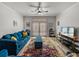 Bright living room with stylish decor, plush blue seating, and a colorful rug offers a cozy ambiance at 4221 W Spruce St # 2302, Tampa, FL 33607