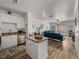 Living room with island, wood floors, white cabinets, and comfortable blue sofa at 4221 W Spruce St # 2302, Tampa, FL 33607