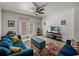 Inviting living room features a modern ceiling fan, comfortable blue sofas, and a vibrant area rug at 4221 W Spruce St # 2302, Tampa, FL 33607