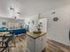 Open-concept living room with island, wood floors, and a comfortable blue sofa at 4221 W Spruce St # 2302, Tampa, FL 33607
