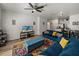 Open-concept living room with hardwood floors, a ceiling fan, and an adjacent modern kitchen offers a comfortable living space at 4221 W Spruce St # 2302, Tampa, FL 33607