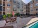 Outdoor crystal blue swimming pool and table with chairs at 4221 W Spruce St # 2302, Tampa, FL 33607