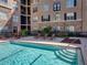 Crystal blue pool, lounge chairs, and landscaping at 4221 W Spruce St # 2302, Tampa, FL 33607