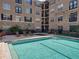 Exterior shot of the building complex including a crystal blue swimming pool and lounge chairs at 4221 W Spruce St # 2302, Tampa, FL 33607
